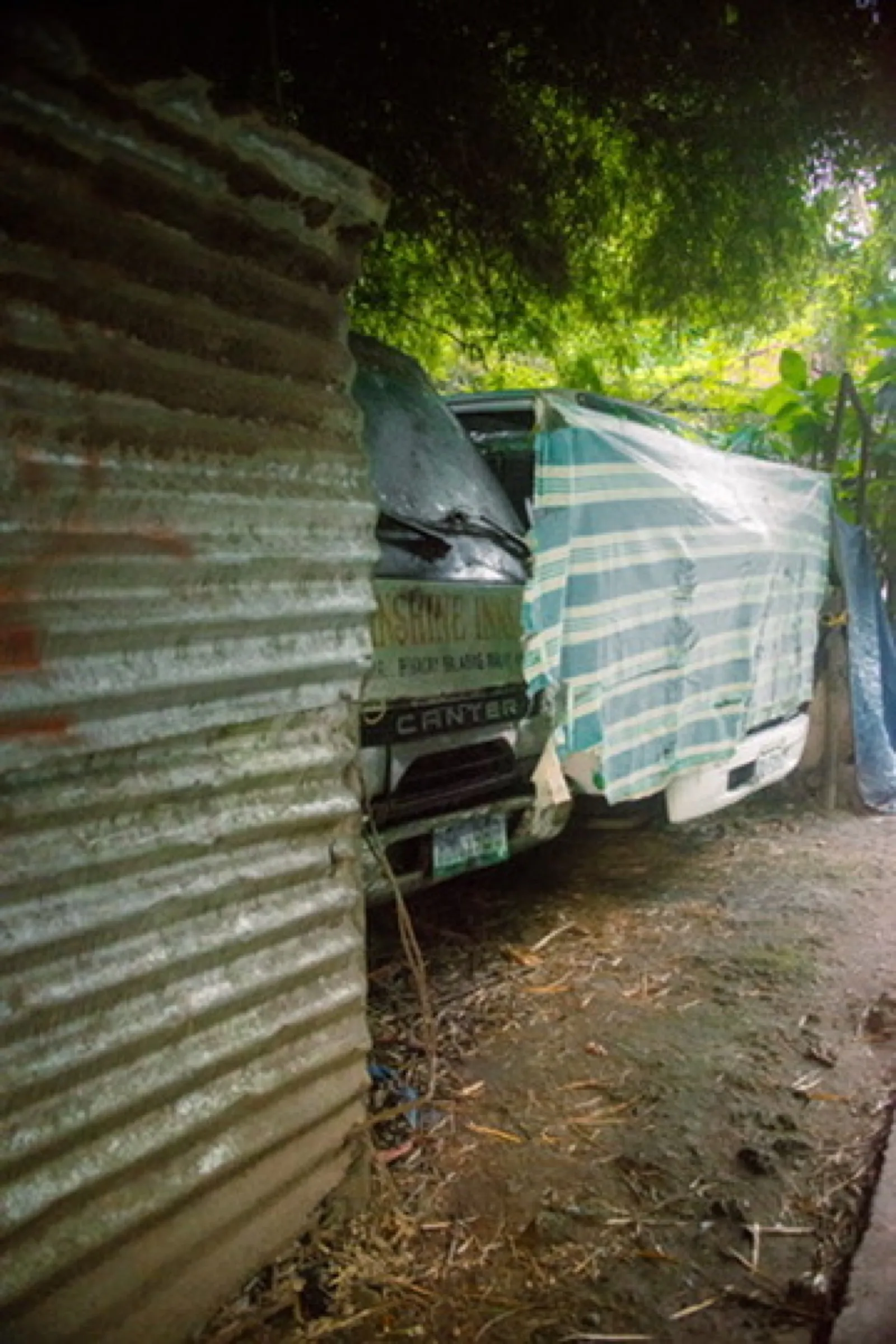 White delivery truck wedged between corrugated walls